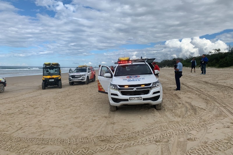 Emergency services vehicles on the beach.