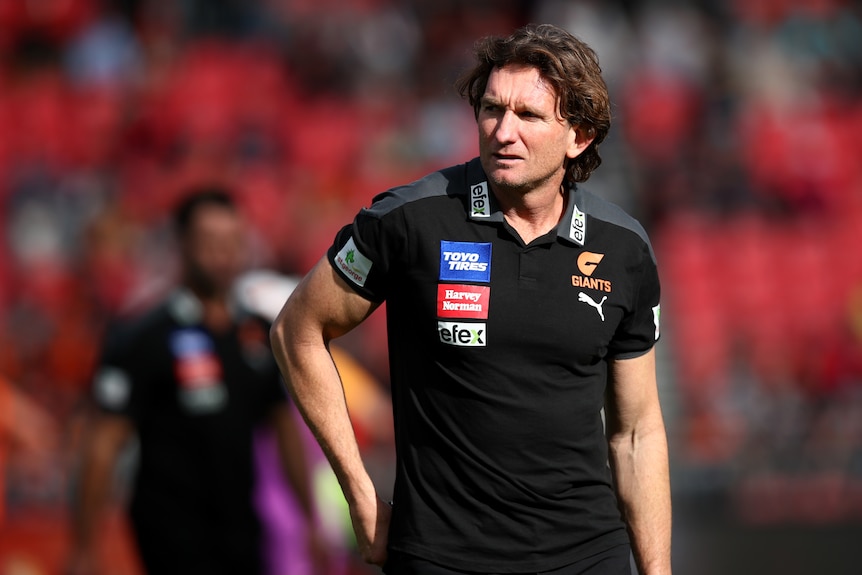 James Hird wearing a GWS Giants AFL polo shirt during a match in 2022.