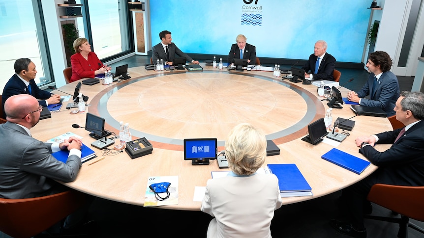 World leaders sit around the table at the top of the G7 meeting in Carbis Bay, England.