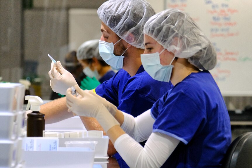 Health workers prepare COVID vaccinations