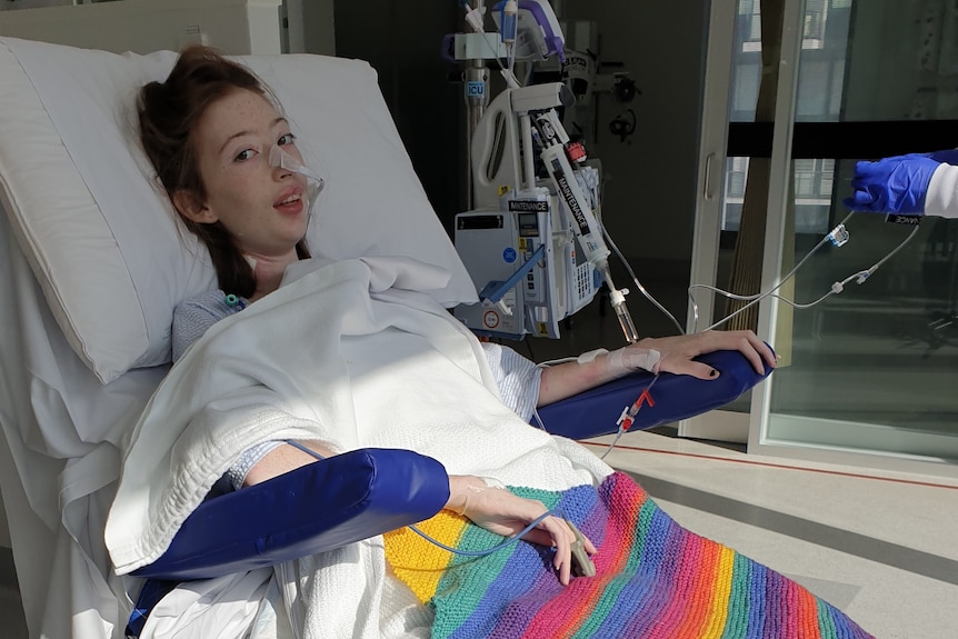 A girl sitting in a hospital bed