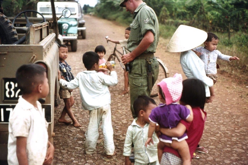 Curious local kids with an Australian soldier