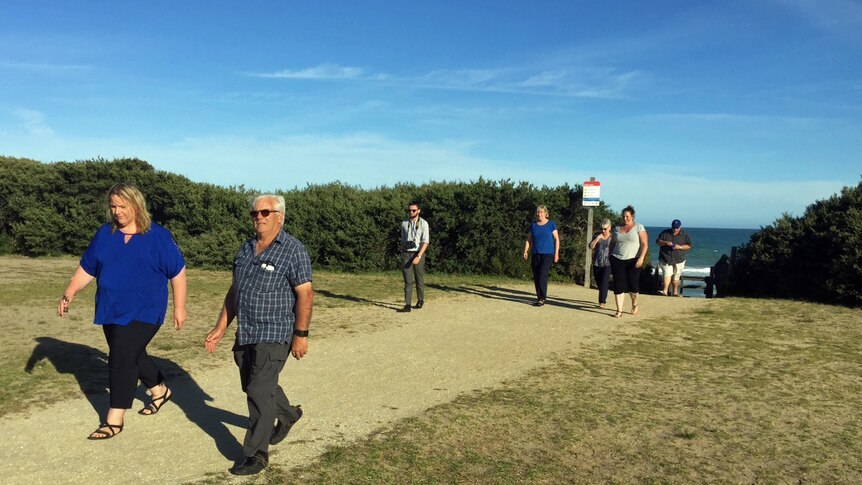 Golden Beach residents walking to community meeting