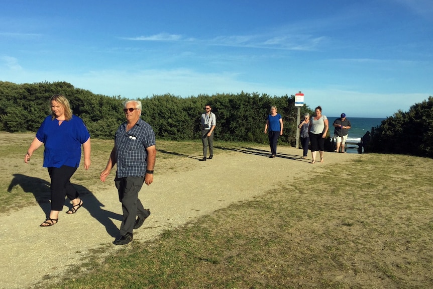 Golden Beach residents walking to community meeting