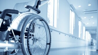 Empty wheelchair in hospital hall [Thinkstock: iStockphoto]