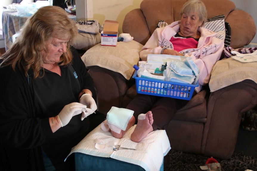 Kathy Mason (L), and her mum Gail Reynolds in bed.