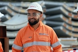 A head shot of Korey Penny wearing a hard hat and safety glasses.