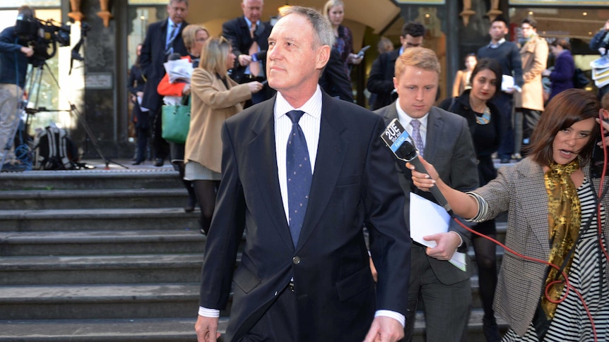 Robert Hughes leaves the Downing Centre courts in Sydney
