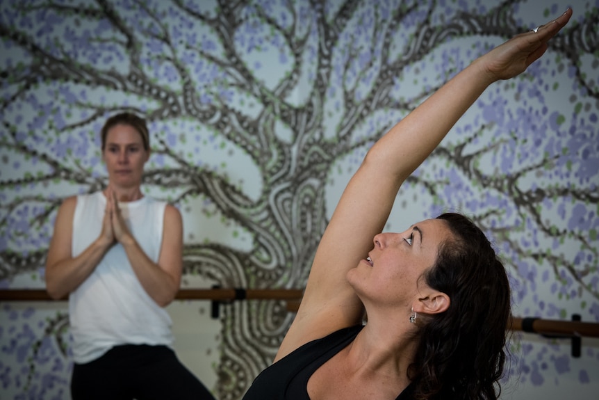 Yoga Instructor Jess Fenech (R) is seen performing a pose during a yoga class in a Sydney studio. Photo taken on March 27 2019