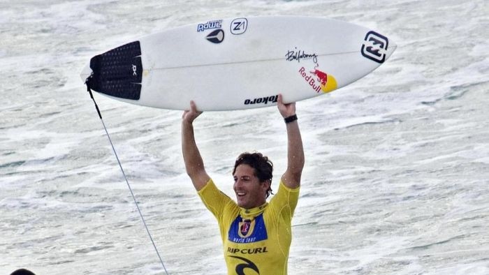 Andy Irons holds up his board after winning the Pipeline Masters
