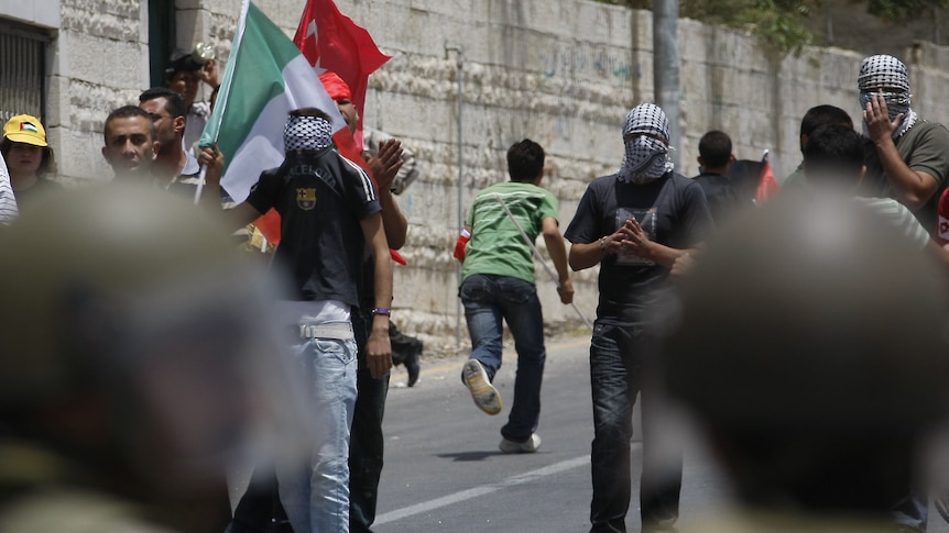 Ongoing tensions: demonstrators face Israeli troops in the West Bank, June 2010