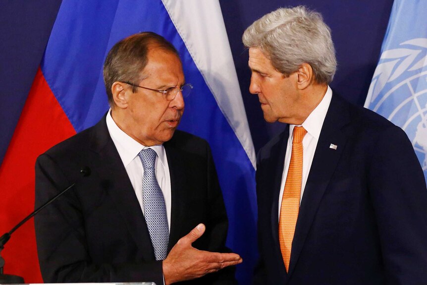 Sergei Lavrov and John Kerry speak to each other while standing at a lectern.