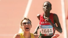 Kerryn McCann crosses the finish line.