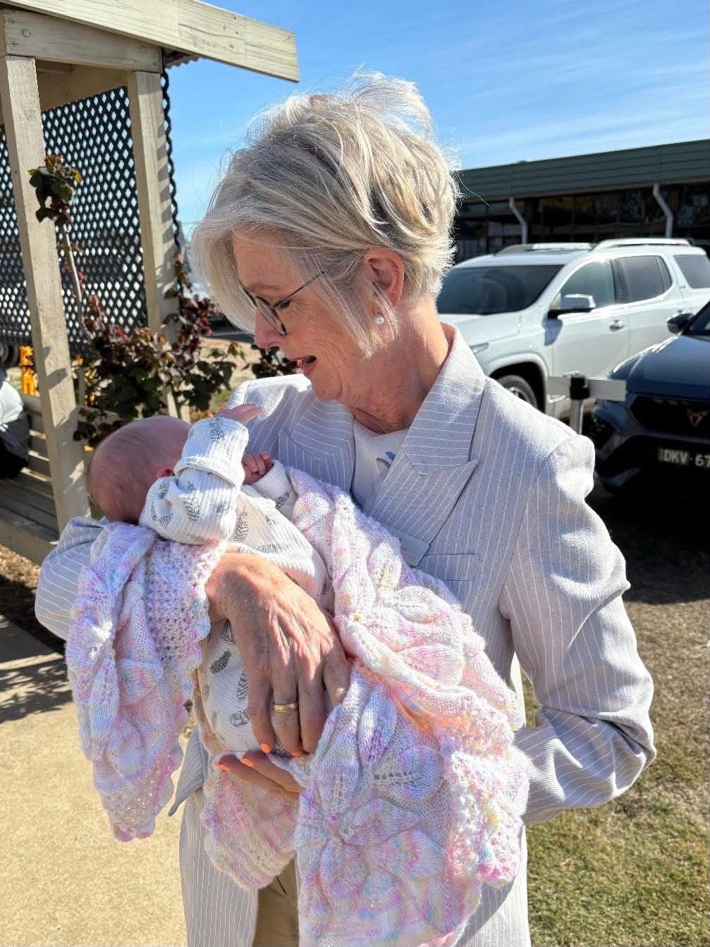 Helen Haines holds a young baby. 