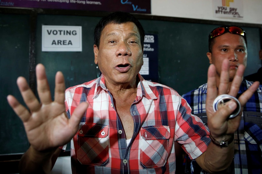 Rodrigo Duterte facing the camera at a polling precinct.