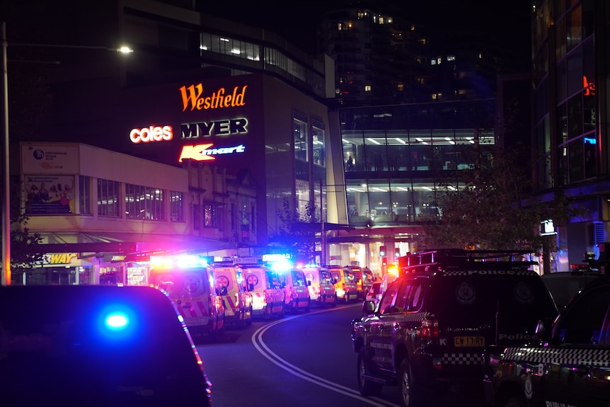 Dozens of police cars and ambulances line the street outside the Westfield Bondi Junction shopping centre
