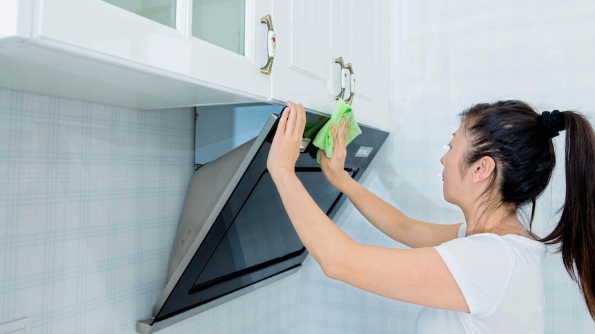 Woman cleaning kitchen