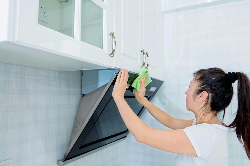 Woman cleaning kitchen