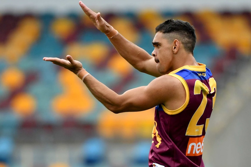 Charlie Cameron does the Baby Shark hand movements after kicking a goal