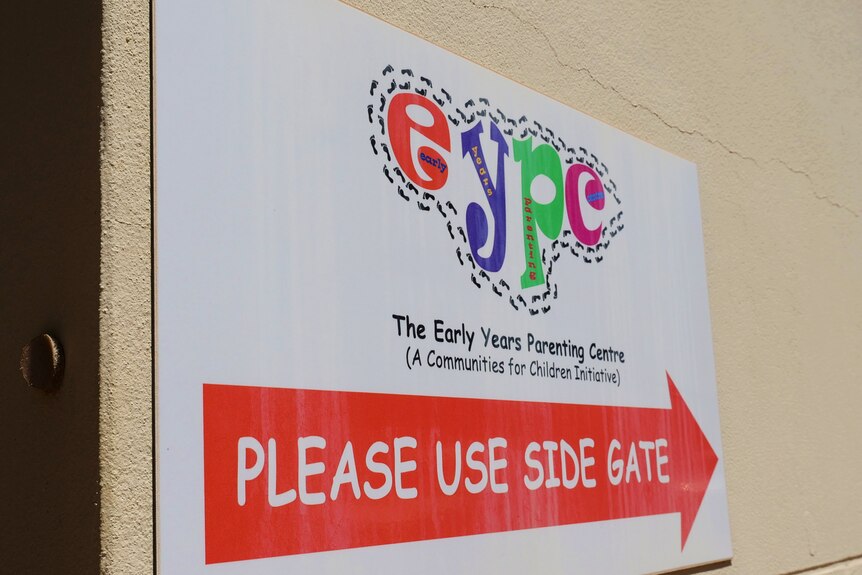 A sign that reads "EYPC, please use side gate" with an arrow.