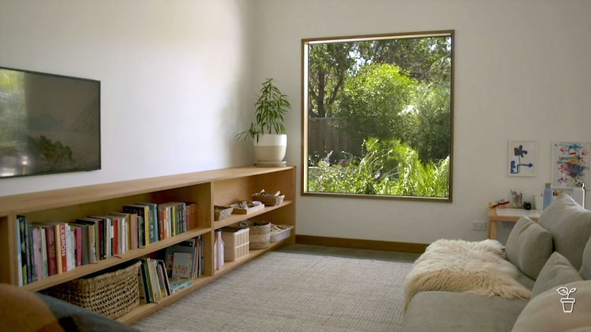 Loungeroom with large window looking out onto a garden.