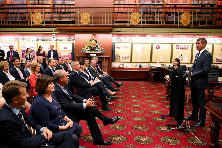 NSW Premier Mike Baird addresses the first party room meeting after the election win