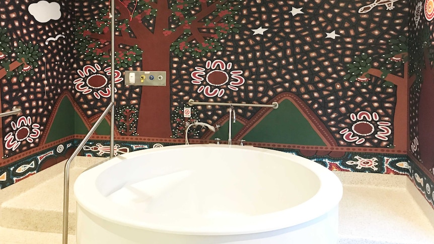 Aboriginal artwork mural in birthing suit surrounds birthing bath