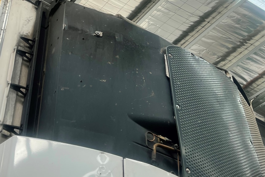 Damage to internal parts of truck after a white panel covering was lost.