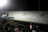 Police and members of the rescue operation stand at the site of a train derailment near Harda, Madhya Pradesh