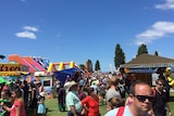 Crowd walks through sideshow alley at Hobart regatta