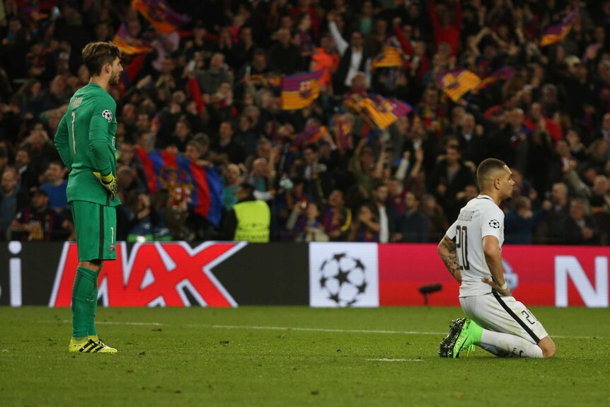 PSG's Layvin Kurzawa (R) and Kevin Trapp show their dejection after the loss to Barcelona.