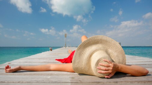 Woman lying on jetty at beach, file photo (Thinkstock)