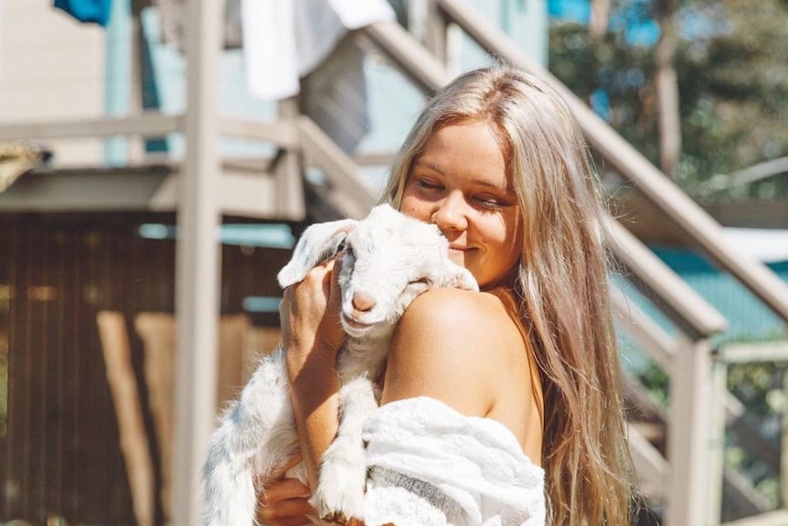 Lauren McGeachin cuddles a goat.