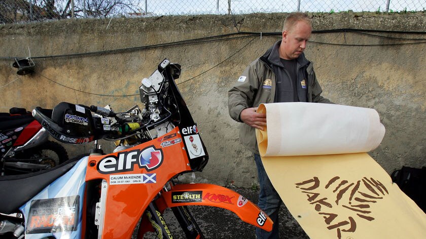 Workers packs away banners after the 2008 Dakar Rally was called off