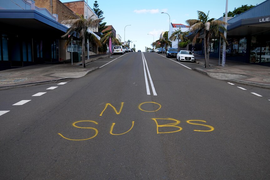 No subs is written in yellow marker across the middle of a street.