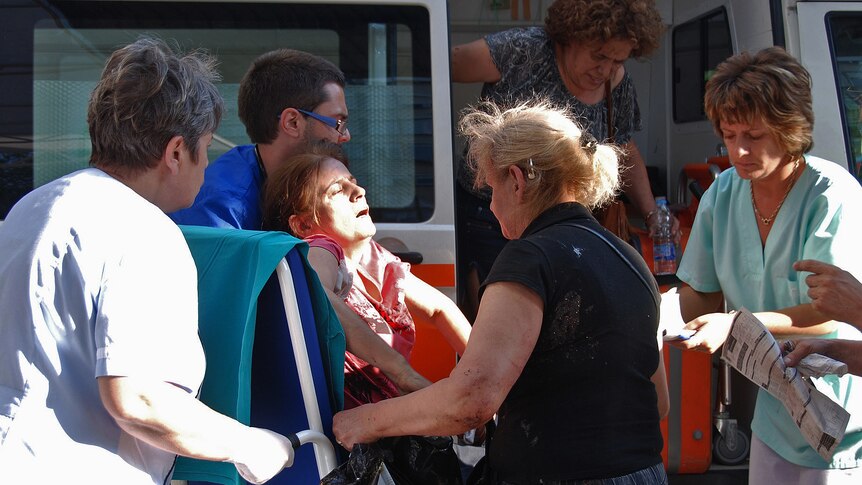 Bulgarian medics help a wounded woman at a hospital after an explosion at Bourgas airport.