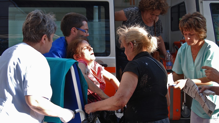 Bulgarian medics help a wounded woman at a hospital after an explosion at Bourgas airport.