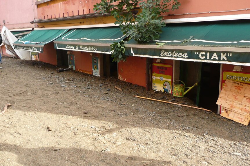 The remnants of a mudslide fill a a street and cafe in the village of Monterosso