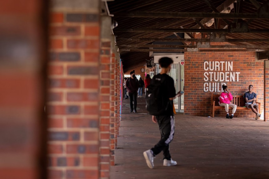 Students near a university guild sign