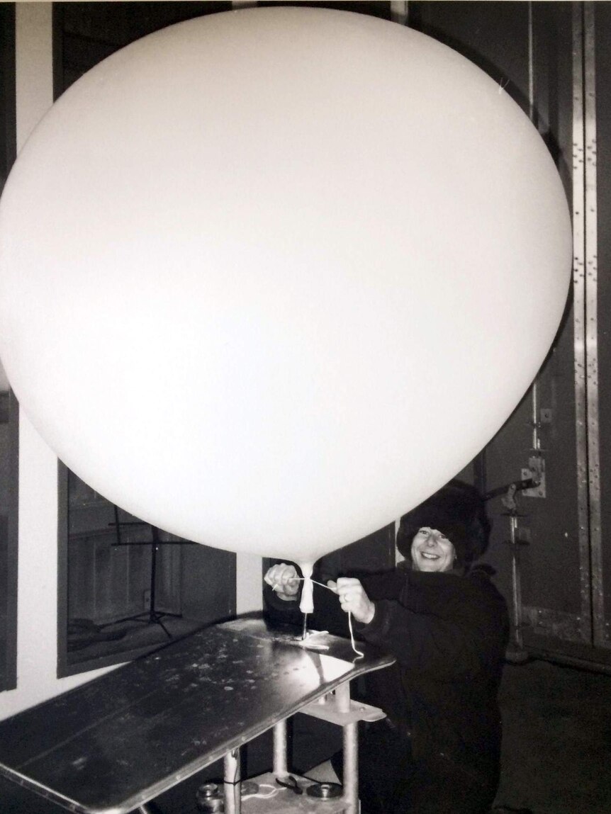 Craig Marsh filling a weather balloon.