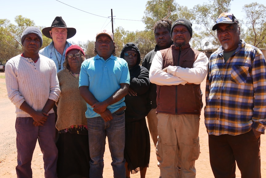 Ken Duncan stands with Haasts Bluff community members