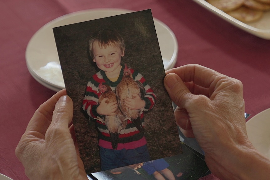 Lachie as a toddler with his hens