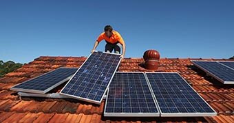 Solar panels are installed on a roof.