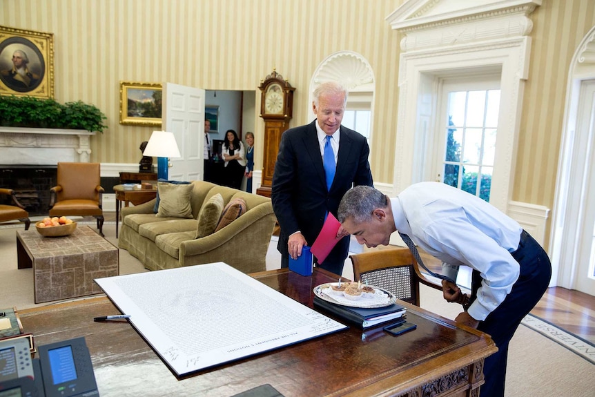 President Barack Obama blows out candles