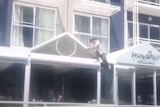 Vision circulated on social media showed a woman climbing down a hotel awning.
