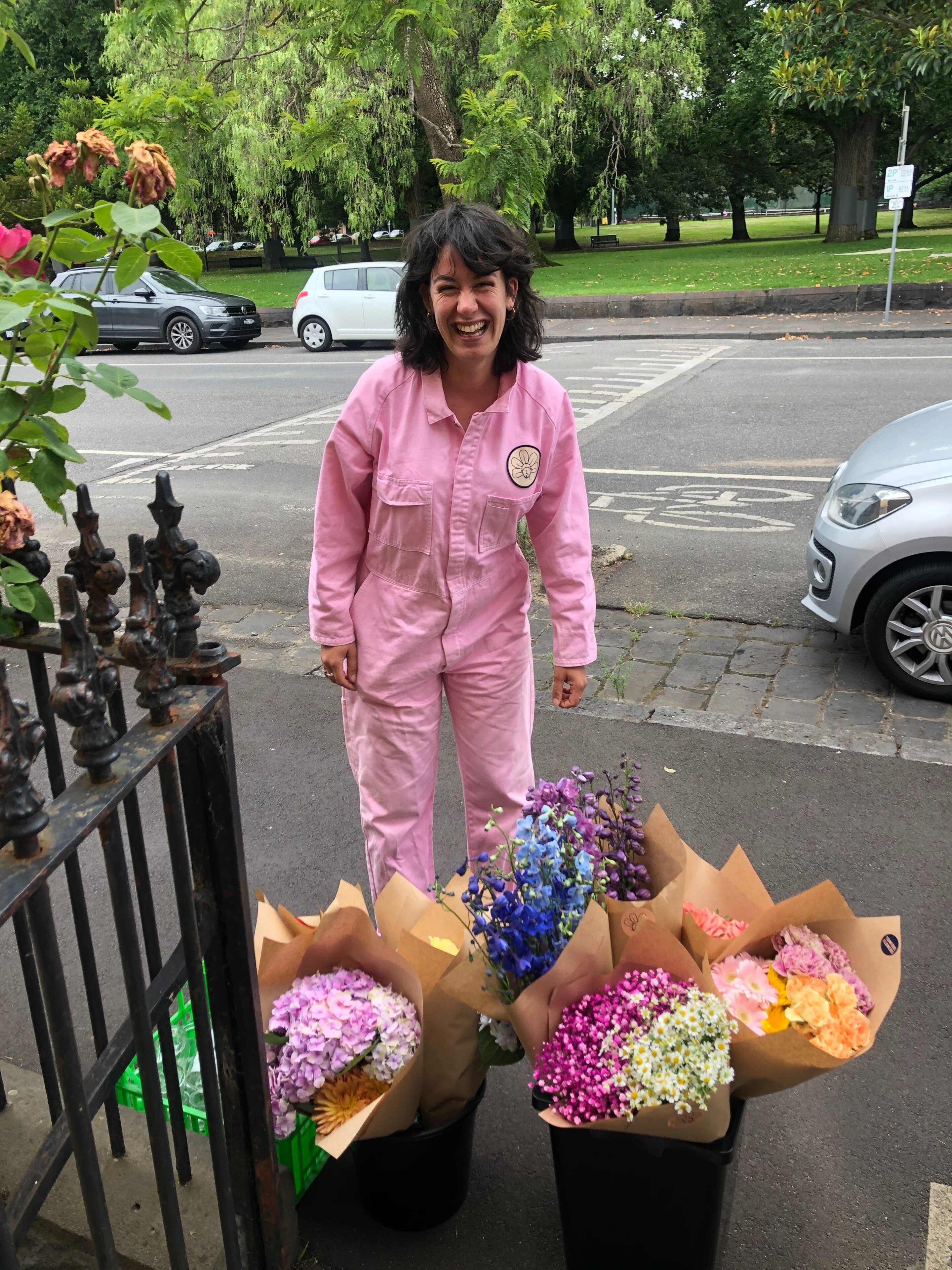 Emely Alakus standing above bunches of flowers