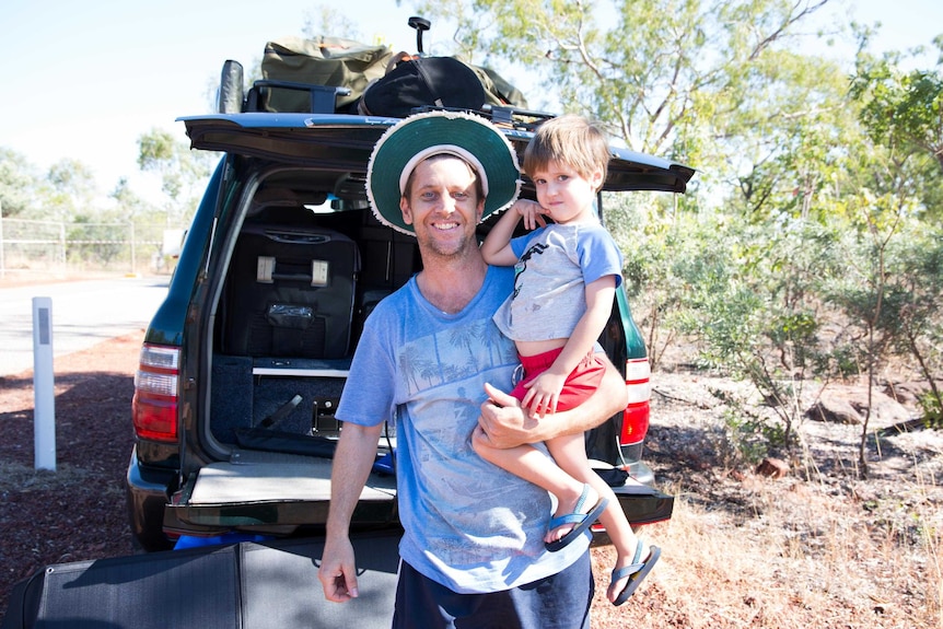 Glenn Gilbert and his son William standing next to their 4WD.
