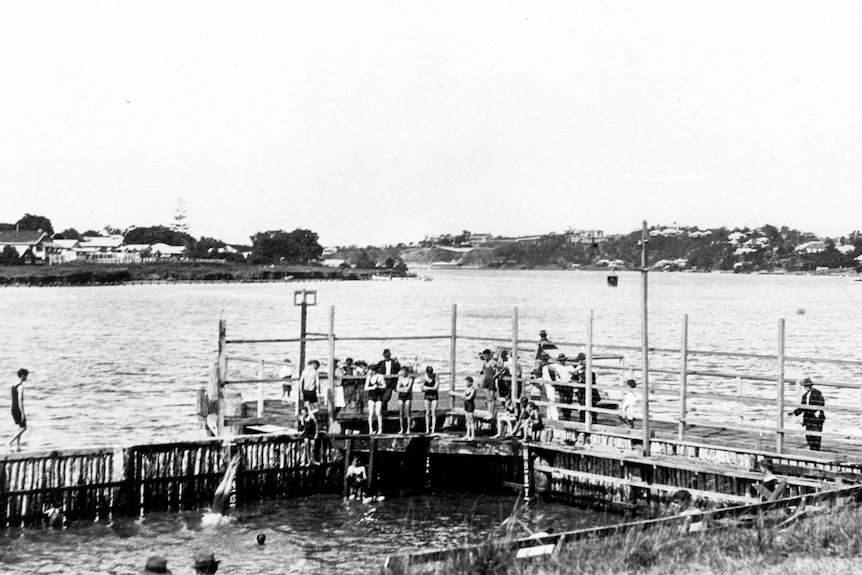 Black and white of families swimming in Brisbane River.