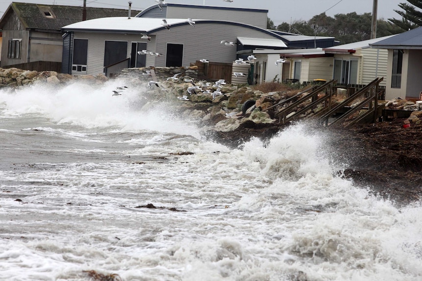 Waves near houses at Pelican Point.