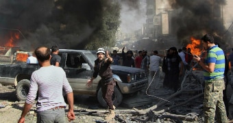 Smoke, flames and chaos is seen after an air strike hits a market.